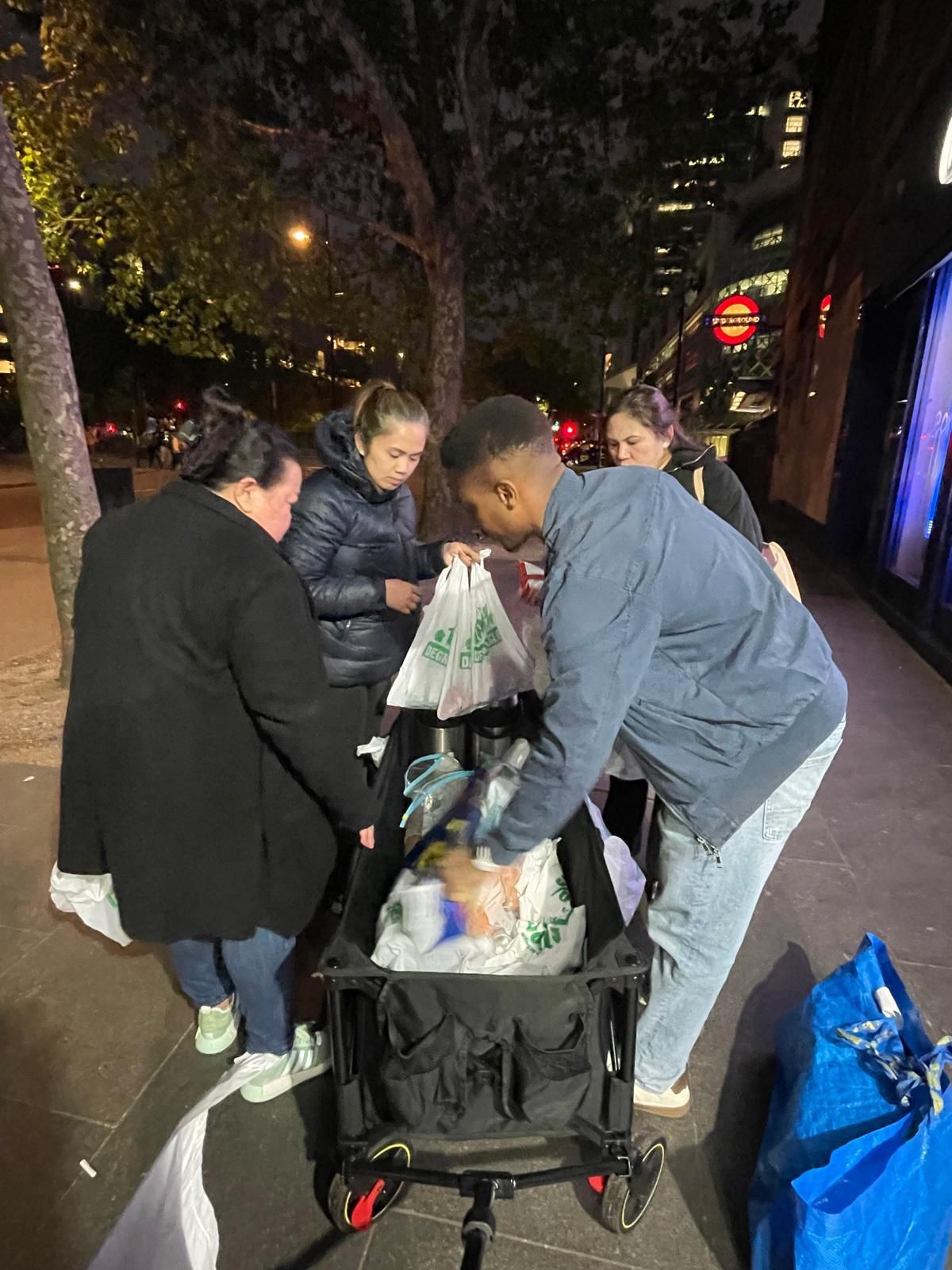 FWA-UK Outreach Committee volunteers organising food and essential supply packs on the streets of central London alongside Under One Sky.