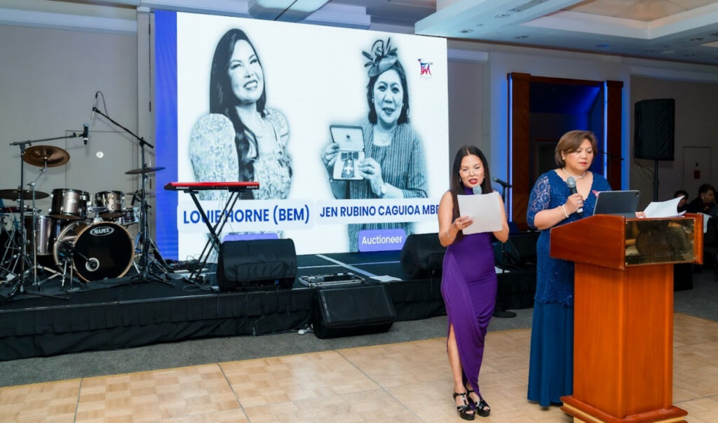 Auctioneers Louie Horne BEM and Jen Rubino Caguioa MBE on stage at the FWA-UK Philippine National Day Gala 2026